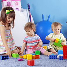 Three children playing with blocks